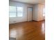 Hardwood flooring, two large windows offering ample light throughout the living room at 6718 Delta Dr, Riverdale, GA 30274