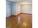 Bright living room with gleaming hardwood floors and natural light from a large window at 6718 Delta Dr, Riverdale, GA 30274