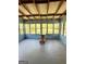 Bright sunroom with multiple windows, a wooden ceiling, and a unique table, perfect for relaxation at 6718 Delta Dr, Riverdale, GA 30274