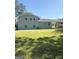 Spacious backyard view showcases a well-maintained lawn, light gray painted brick home and covered parking area at 6505 Allatoona Rd, Morrow, GA 30260