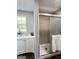 Bathroom featuring a vanity, a window with natural light, and a glass-enclosed shower at 6505 Allatoona Rd, Morrow, GA 30260
