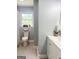 Bright bathroom featuring a tub/shower, toilet, modern vanity and natural light from the window at 6505 Allatoona Rd, Morrow, GA 30260