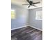 Spacious empty bedroom featuring new flooring, and natural light from two windows at 6505 Allatoona Rd, Morrow, GA 30260