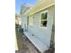 This light gray painted brick home exterior features a concrete walkway and a neatly installed air conditioning unit at 6505 Allatoona Rd, Morrow, GA 30260
