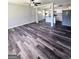 Spacious living room with stylish flooring, ceiling fan, and an open layout to the kitchen at 6505 Allatoona Rd, Morrow, GA 30260