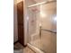 Bathroom with sliding shower doors and adjacent built in cabinet at 2215 Mount Carmel Rd, Hampton, GA 30228