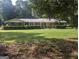 Charming brick ranch home with large front yard and mature landscaping at 2215 Mount Carmel Rd, Hampton, GA 30228