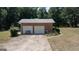 Two-car brick garage with an extended driveway and a bench at 2215 Mount Carmel Rd, Hampton, GA 30228