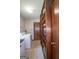 Bright laundry room features wooden shelving, tile floors, and modern appliances at 2215 Mount Carmel Rd, Hampton, GA 30228