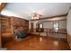 Living room with hardwood floors, brick fireplace with built-in shelves, and ceiling fan at 2215 Mount Carmel Rd, Hampton, GA 30228
