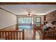 Spacious living room featuring hardwood floors, brick fireplace, and open floor plan at 2215 Mount Carmel Rd, Hampton, GA 30228