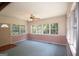 Bright living room featuring a ceiling fan and large windows showcasing the outdoor view at 2215 Mount Carmel Rd, Hampton, GA 30228