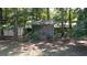 Rustic shed in a wooded backyard surrounded by foliage at 2215 Mount Carmel Rd, Hampton, GA 30228