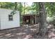 Two sheds in wooded area, one with siding and one open structure at 2215 Mount Carmel Rd, Hampton, GA 30228