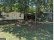 Sheds in a wooded area; one has siding, the others are rustic at 2215 Mount Carmel Rd, Hampton, GA 30228