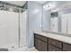 Stylish bathroom featuring a glass-enclosed shower, granite vanity, and modern lighting fixtures at 488 Jefferson Chase St, Atlanta, GA 30354