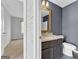 Bathroom view featuring a modern vanity and fixtures, complemented by stylish gray walls at 488 Jefferson Chase St, Atlanta, GA 30354