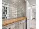 Hallway featuring unique mirrored tile work and a wooden storage console with decorative molding at 488 Jefferson Chase St, Atlanta, GA 30354