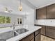 Open kitchen with a large island, stainless steel sink, and views of the living area and backyard at 488 Jefferson Chase St, Atlanta, GA 30354