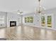 Spacious living room with a fireplace, wood floors, modern lighting, and access to the backyard patio at 488 Jefferson Chase St, Atlanta, GA 30354