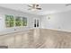 Bright living room featuring modern ceiling fan, windows, and wood-look flooring, with doors to the outside at 488 Jefferson Chase St, Atlanta, GA 30354