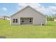 Expansive backyard showcases a covered patio, ample green space, and privacy at 1033 Claas Way, Locust Grove, GA 30248