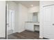 Bathroom featuring granite counters, a vanity with storage, mirror, and wood look floors at 1033 Claas Way, Locust Grove, GA 30248