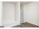 Well-lit bathroom with shower, tub, and wood look floors at 1033 Claas Way, Locust Grove, GA 30248