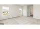 Bright bedroom featuring neutral carpet, crisp white walls, and multiple windows allowing ample natural light at 1033 Claas Way, Locust Grove, GA 30248