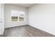 Bright bedroom featuring sleek flooring, window with neighborhood view, and ample natural light at 1033 Claas Way, Locust Grove, GA 30248