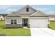 Charming single-Gathering home boasts neutral siding, a two-car garage, and inviting curb appeal at 1033 Claas Way, Locust Grove, GA 30248