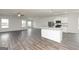 Bright and open living space with sleek flooring and large windows allowing ample natural light at 1033 Claas Way, Locust Grove, GA 30248
