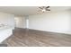 Spacious living room with sleek floors, ceiling fan, and open layout, perfect for modern living at 1033 Claas Way, Locust Grove, GA 30248