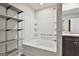 Bathroom showcasing a soaking tub and shower combination with built-in shelving at 130 S Meadows Ridge Dr, Grantville, GA 30220