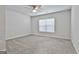 Bright bedroom features neutral gray carpeting and fan with natural light at 130 S Meadows Ridge Dr, Grantville, GA 30220