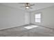 Bedroom with neutral gray carpeting, ceiling fan, and ample natural light at 130 S Meadows Ridge Dr, Grantville, GA 30220