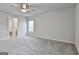 Spacious bedroom features neutral gray carpeting and fan with an attached bathroom at 130 S Meadows Ridge Dr, Grantville, GA 30220
