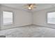 Bright bedroom with neutral walls, carpeting, and large windows with blinds at 130 S Meadows Ridge Dr, Grantville, GA 30220