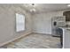 Cozy dining area with chandelier and stainless steel refrigerator and hardwood floors at 130 S Meadows Ridge Dr, Grantville, GA 30220