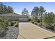 A long driveway leads to a spacious two-car garage, surrounded by neat landscaping at 130 S Meadows Ridge Dr, Grantville, GA 30220
