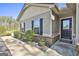Charming front entrance featuring a dark front door, neat landscaping and a sidewalk at 130 S Meadows Ridge Dr, Grantville, GA 30220