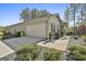 Attached two-car garage with a wide driveway and neatly trimmed landscaping at 130 S Meadows Ridge Dr, Grantville, GA 30220