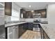 Modern kitchen featuring stainless appliances, granite countertops and dark wood cabinets at 130 S Meadows Ridge Dr, Grantville, GA 30220