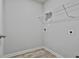Laundry room boasts wood-look flooring, neutral walls, and utility connections at 130 S Meadows Ridge Dr, Grantville, GA 30220