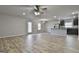 Open-concept living room with hardwood floors and modern ceiling fan fixture at 130 S Meadows Ridge Dr, Grantville, GA 30220