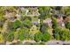 An aerial perspective of a home surrounded by lush greenery, with a sprawling lawn and mature trees at 25 Hickory Dr, Stockbridge, GA 30281