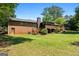 View of the backyard featuring a large brick home with stairs and patio at 25 Hickory Dr, Stockbridge, GA 30281