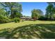 Expansive backyard featuring lush green grass and mature trees, perfect for outdoor activities and relaxation at 25 Hickory Dr, Stockbridge, GA 30281