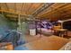 Unfinished basement with exposed beams and cinderblock walls, plus workbench and laundry machine at 25 Hickory Dr, Stockbridge, GA 30281
