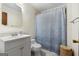 Bathroom with blue-patterned shower curtain, mirror, white vanity and toilet, plus woven basket at 25 Hickory Dr, Stockbridge, GA 30281